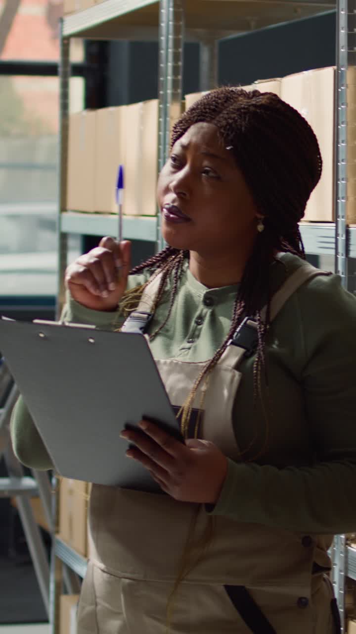 Vertical video Manager reviews warehouse inventory