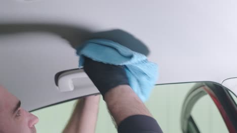 professional car cleaning. сar wash. interior detailing. dry clean and detail a car interior. deep seats cleaning. wiping foam in car wash. cleaning the car panel from dust. a vacuum cleaner