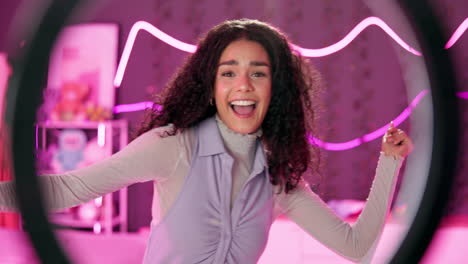 woman smiling in front of a ring light