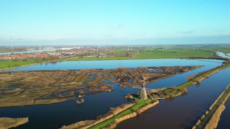 aerial backwards drone shot of traditional windmills in kinderdijk in autumn