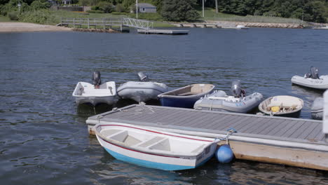 small boats docked at the lake in gentle waves