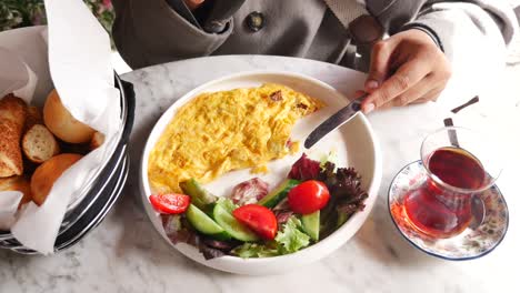 person eating turkish breakfast