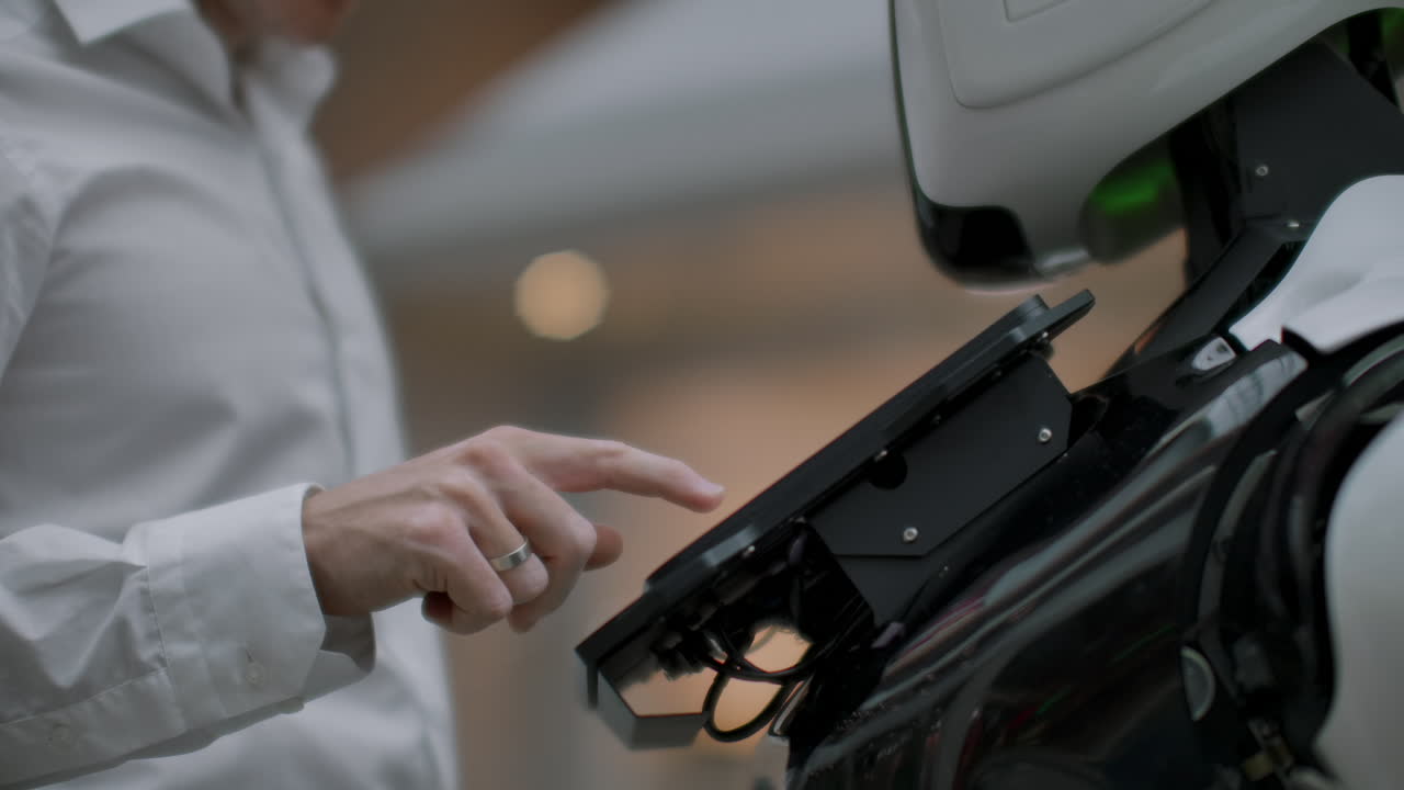 Ein Mann im Einkaufszentrum kommuniziert mit einem Roboter-Berater. Moderner Laden und Roboterverkäufer. Der Roboter hilft einem Mann im Einkaufszentrum.