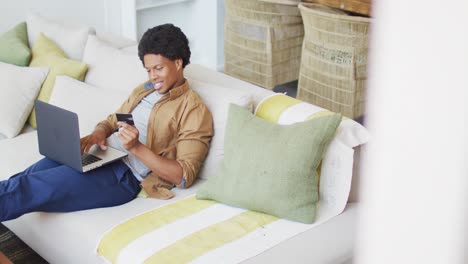 African-american-man-using-laptop-at-home