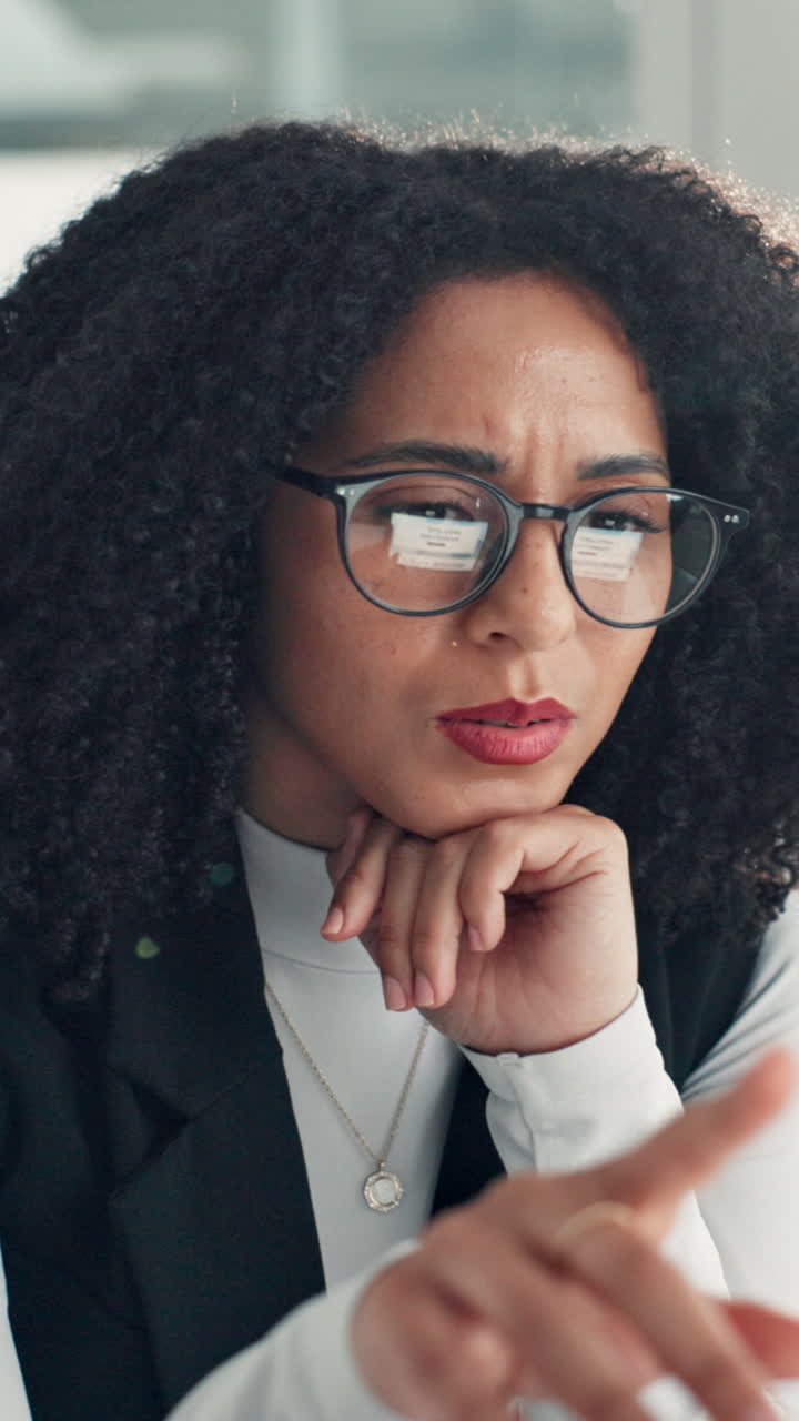 Focused Businesswoman Thinking and Pointing While Looking at a Screen