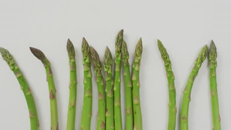 video of fresh asparagus over white background