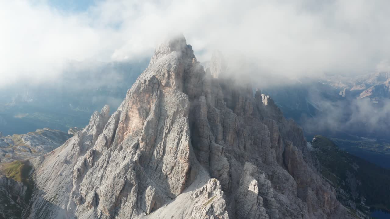 Vista aerea ravvicinata delle drammatiche cime della Croda da Lago tra nuvole sottili, Dolomiti