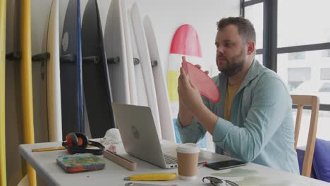 male surfboard maker in his workshop