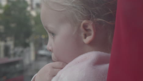 child exploring the city with mum from open window