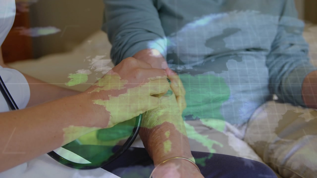 Animation of world map over caucasian doctor treating patient
