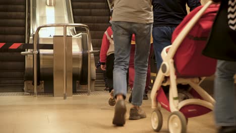 people using a moving staircase in a metro station