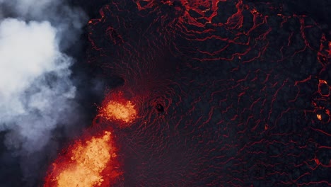 burning lava on surface of earth, active fissure volcano spewing magma, lava river, top down aerial