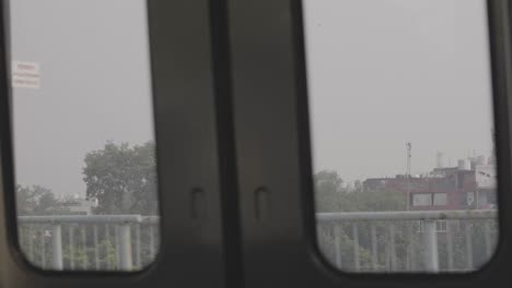 delhi metro moving crossing a station