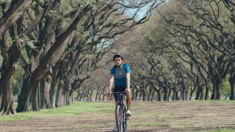 male cyclist having bike ride outdoors in the park