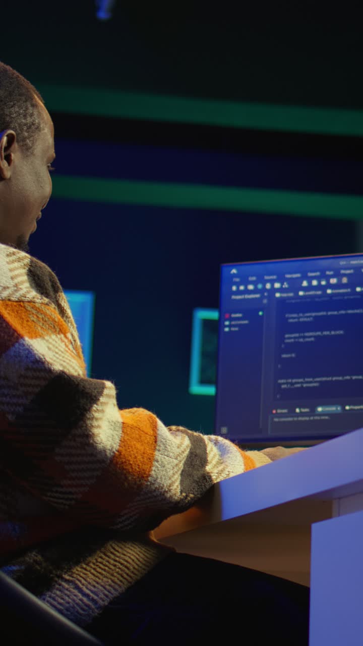 Vertical Video Black software engineer writes complex binary code scripts on computer