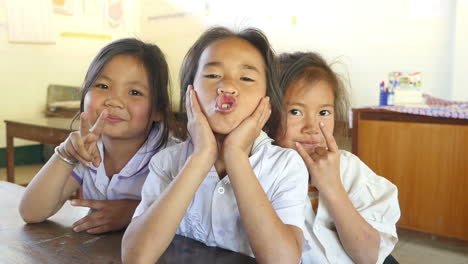 happy schoolgirls in classroom