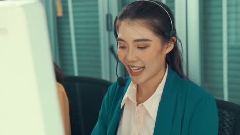 businesswoman wearing headset working actively in office