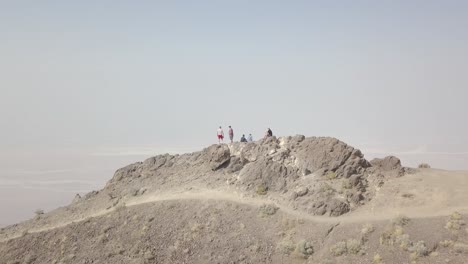 aerial drone shot of group of people on mountain in death valley