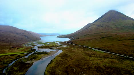 road and river running into lake in isle of skye scotland- aerial