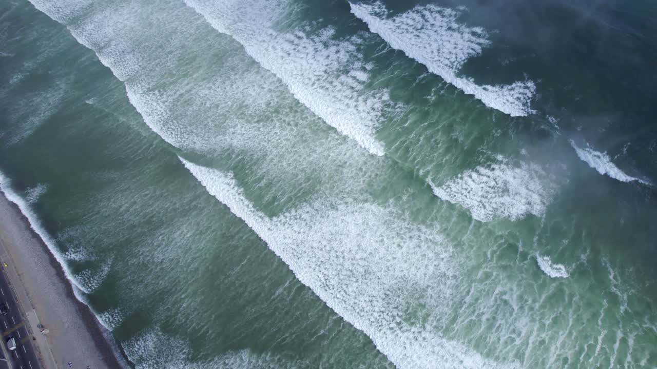 Aerial View of Waves Crashing on the Shore