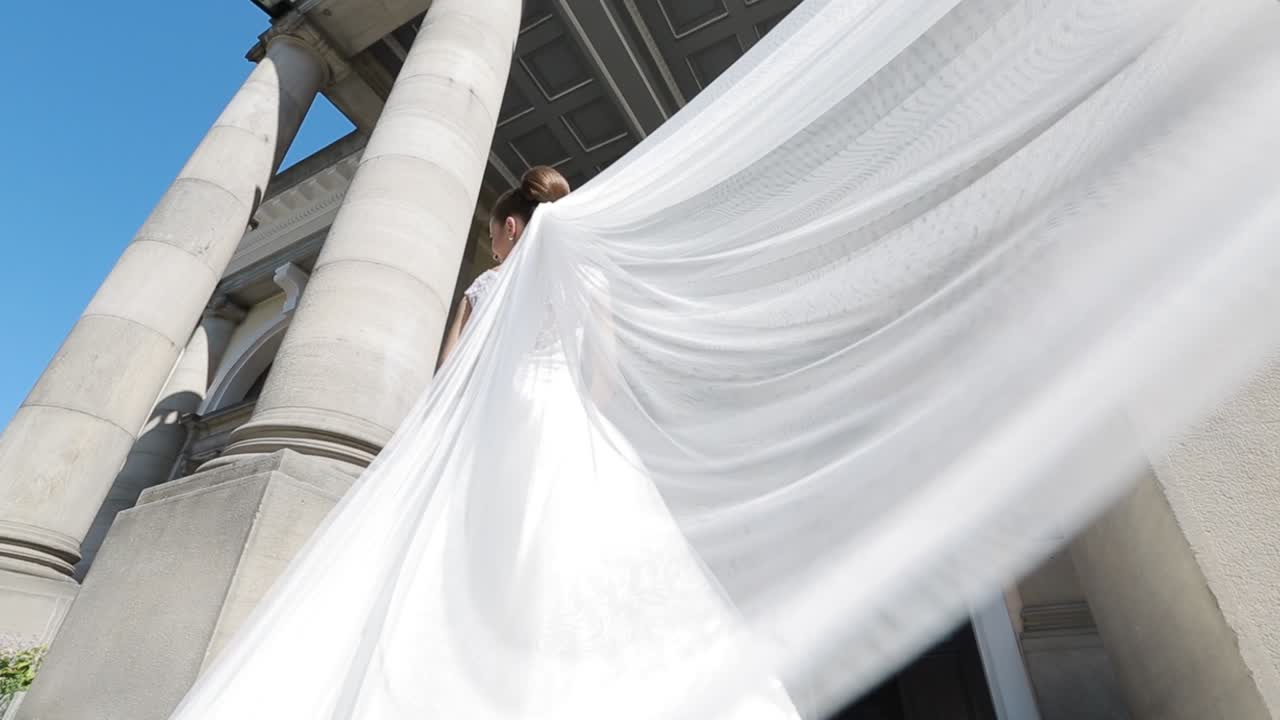 Bride Posing Between The Columns. Beautiful bride posing between the columns of the old house