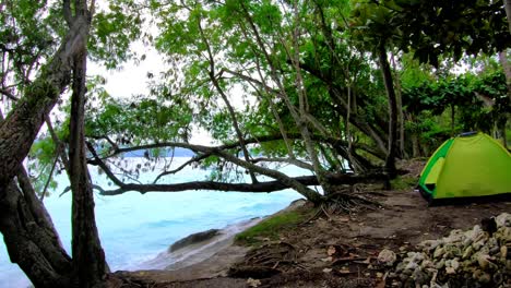 a-tent-uphill-with-a-view-of-blue-waters-splashes-the-pile-rocks