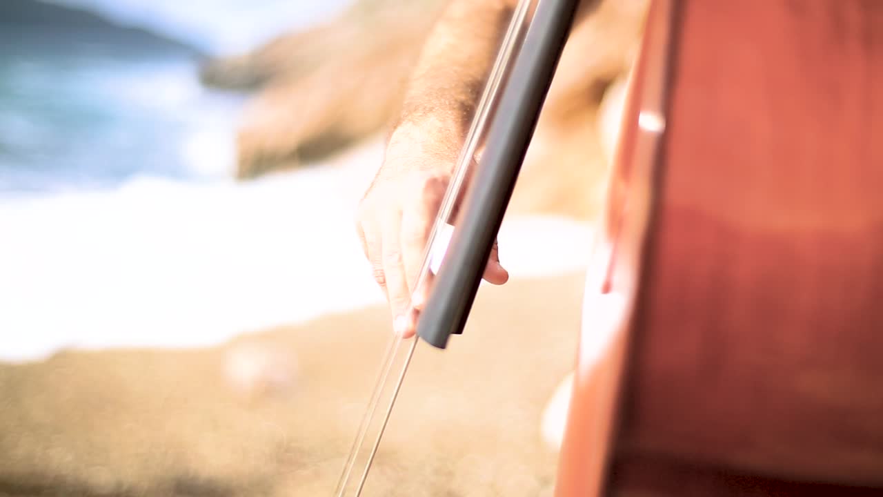 Cellist Playing on a Beach