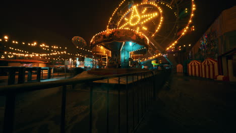 an empty amusement park filled with colorful lights at night