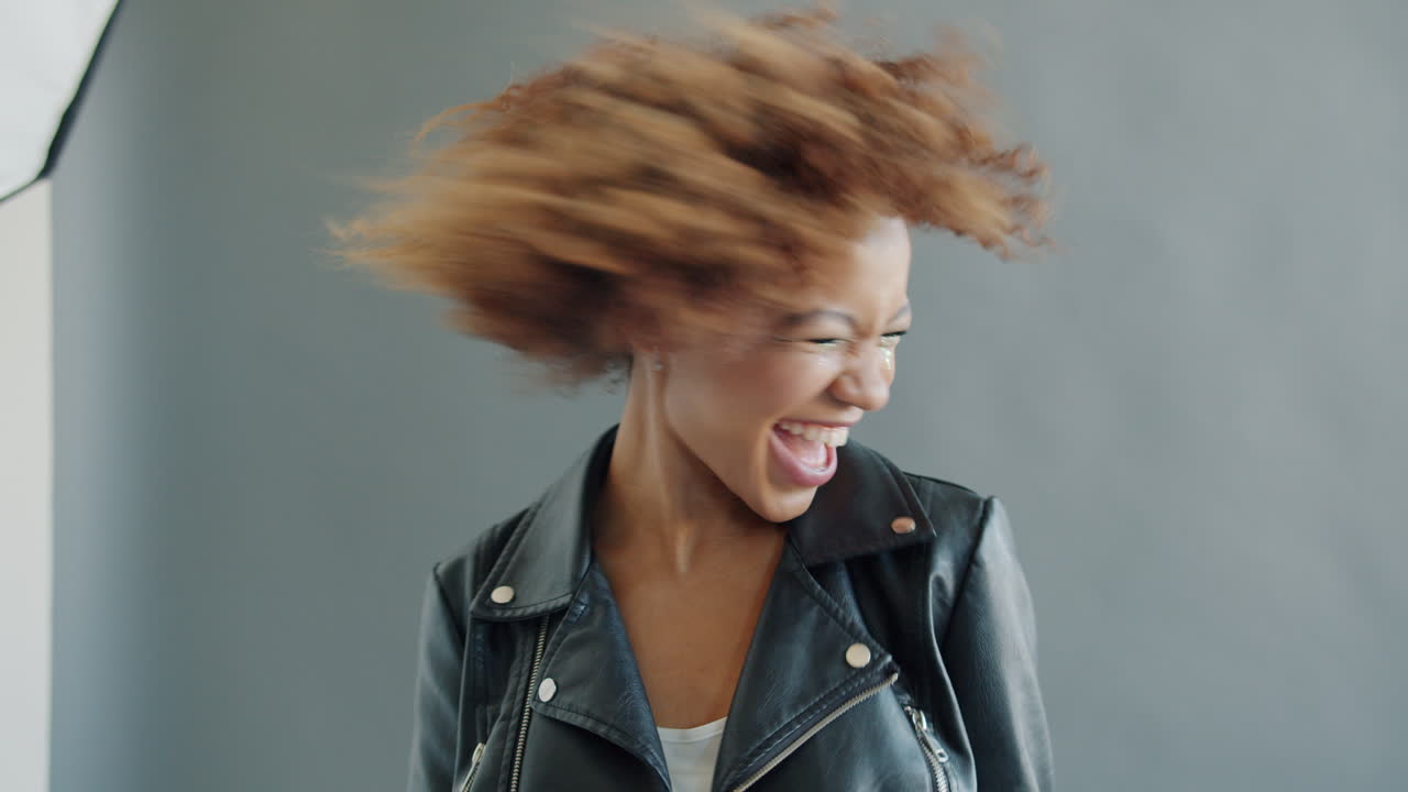 Happy Woman with Curly Hair in Studio