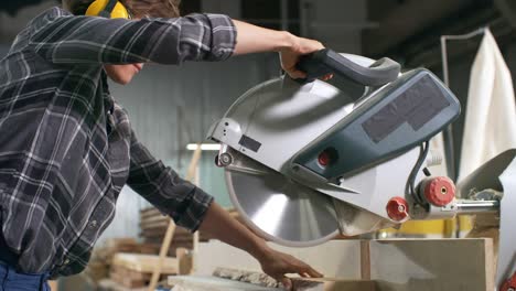 woman cutting wood with circular saw