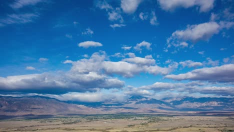 time lapse - beautiful cloudscape moving over mountain range and the valley