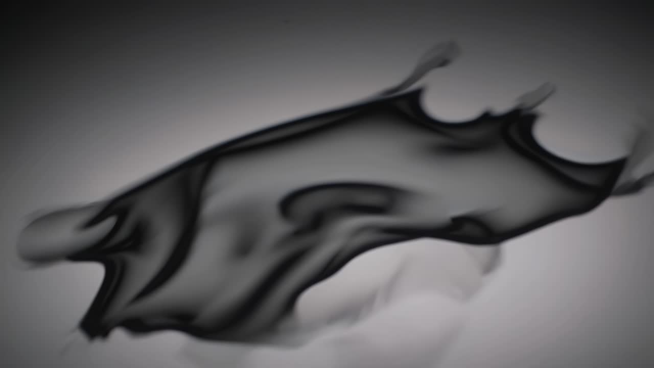 Flowing black fabric gracefully undulates and transforms in a mesmerizing motion sequence, showcasing the beauty of movement and texture in a dynamic display