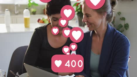 Animation-of-heart-emojis-and-numbers-over-happy-caucasian-female-couple-in-love