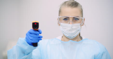 doctor measuring patient temperature at health care clinic 6