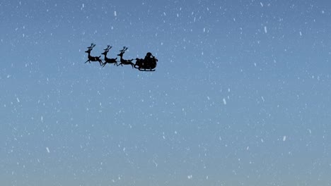 silhouette of santa claus on sled flying with reindeer against blue sky during snowfall