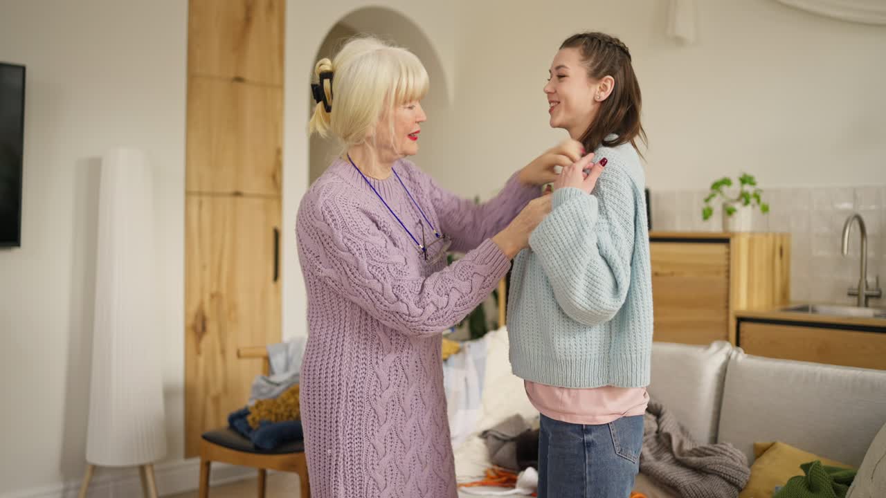 Grandmother Helping Granddaughter Dress