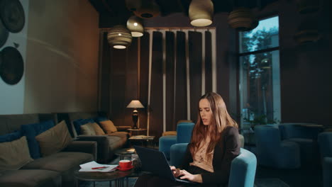 thoughtful woman working laptop computer in office. focused business woman
