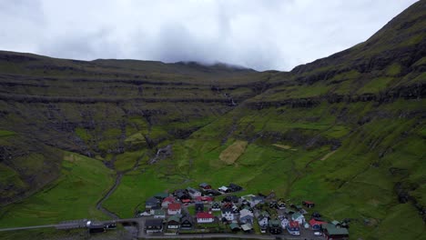 drone flying slowly over tjornuvik heading to the volcanic mountain peaks