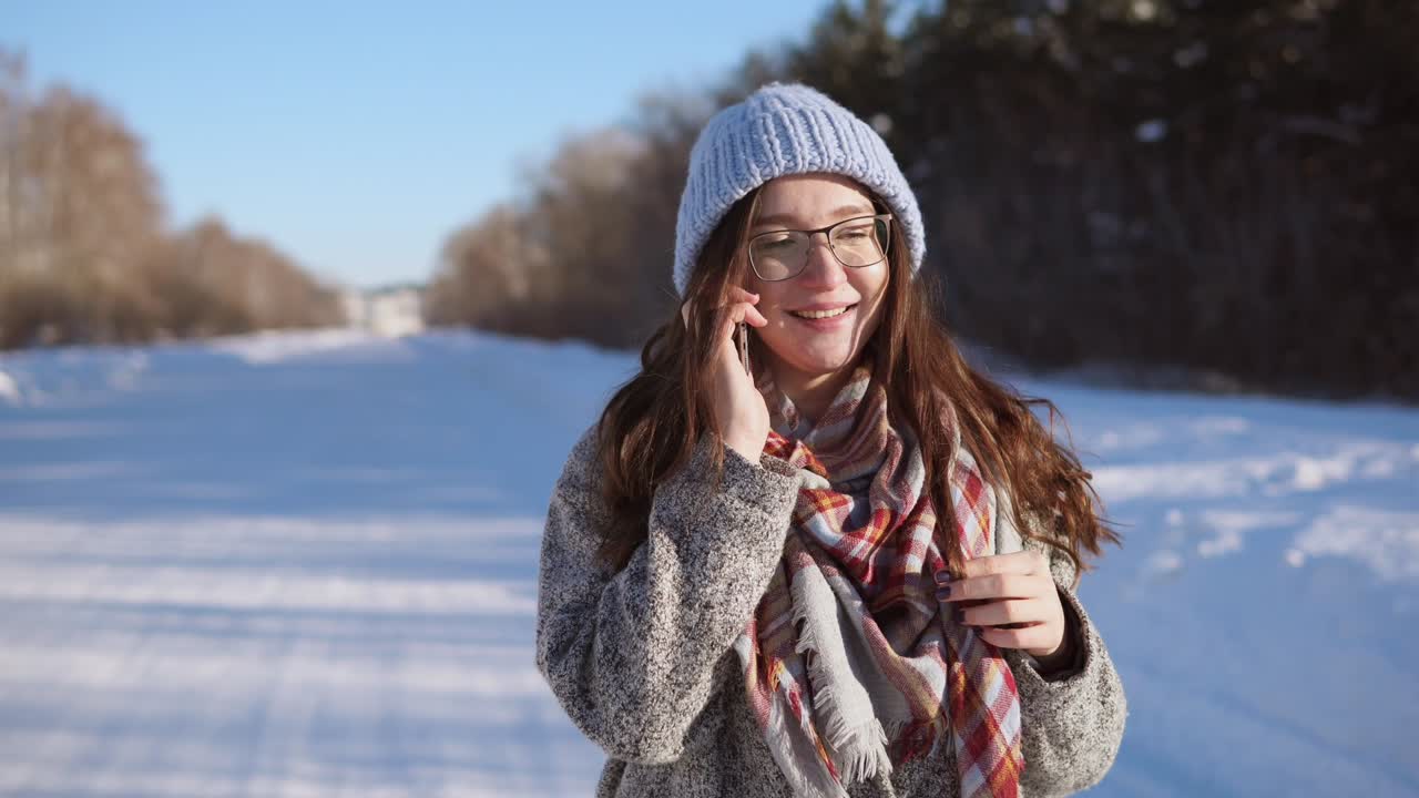Woman Talking on Phone in Snowy Winter Scene