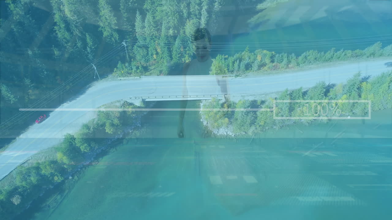 Aerial view of road and forest with data processing animation overlay