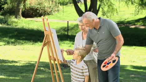 Grandparents-and-grandson-painting-a-canvas