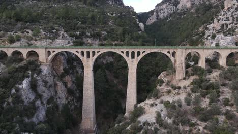 drone shot of the big bridge built over the canyon, aerial view of an old historical bridge