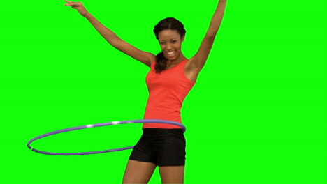 woman playing with a hula hoop on green screen