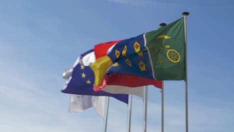 Flags-flying-in-the-monastery-of-santo-estevo-of-ribas-of-sil,-ourense,-spain