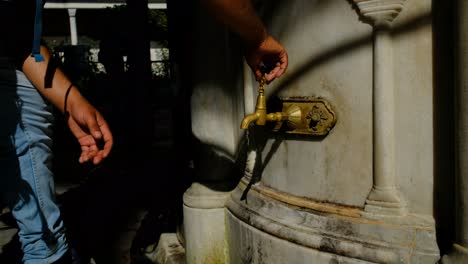 Hagia-Sophia-Fountain-man-washing-his-hands-at-the-fountain