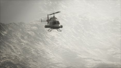 extreme slow motion flying helicopter near mountains with fog