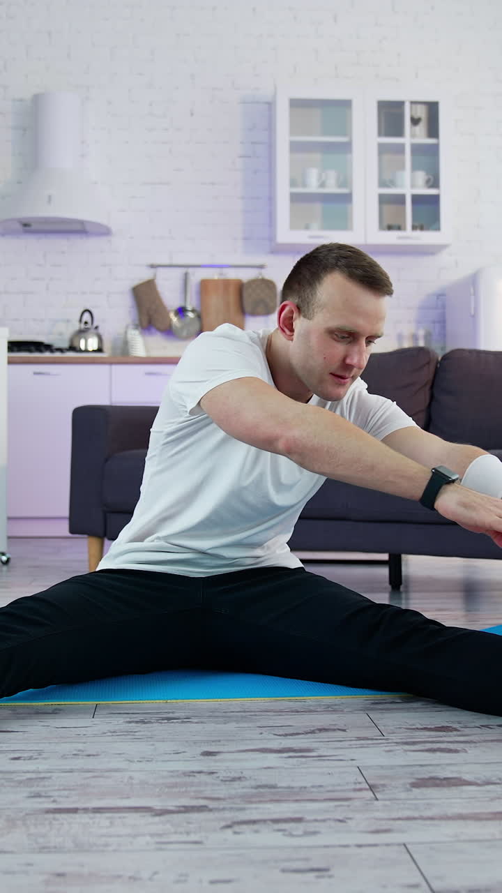Young athletic healthy male training indoors. Strong man on quarantine working out in home