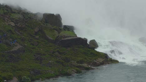 water gushing down waterfall surrounded by large rocks