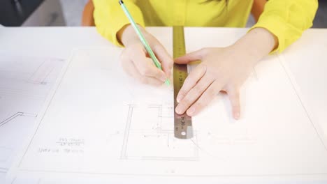 close-up talented interior designer woman drawing on project.