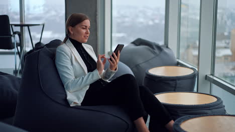 businesswoman using smartphone in a modern office